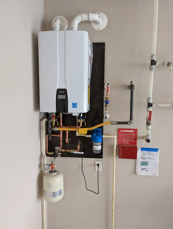 Professional plumber installing copper piping in a Papillion home